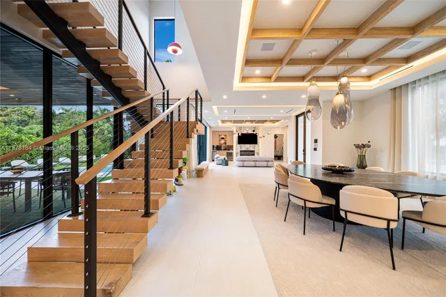 a view of a hallway with dining room and workspace