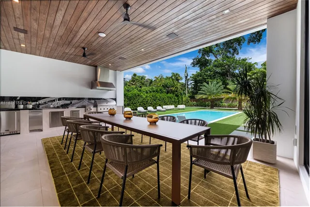 a living room with patio furniture and a flat screen tv