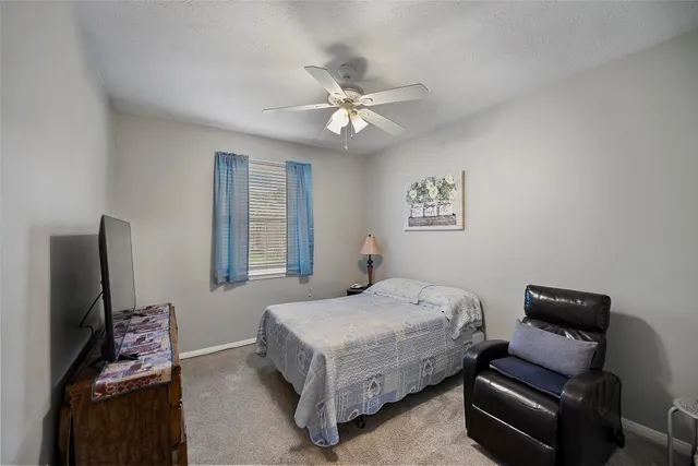 a bedroom with a bed couch and a window