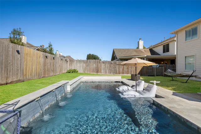 a view of a backyard with sitting area
