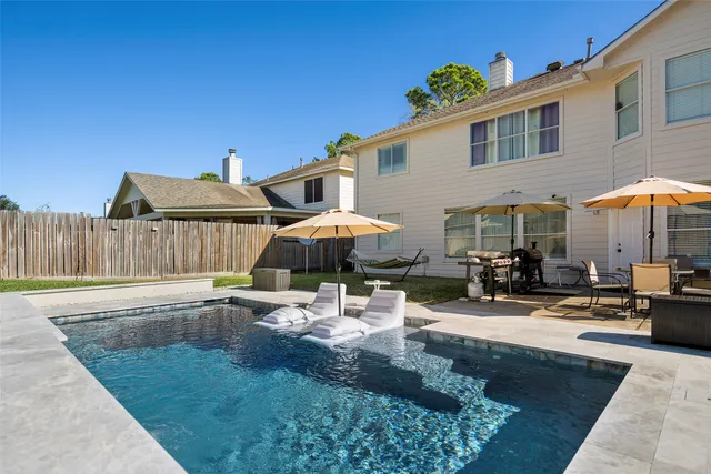 a view of a house with backyard outdoor seating area and furniture