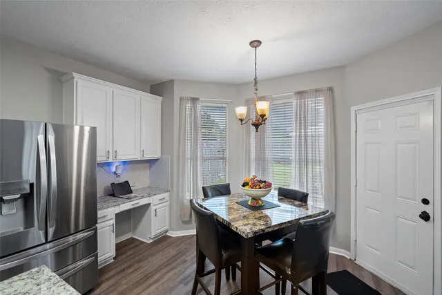 a kitchen with stainless steel appliances granite countertop a sink refrigerator and microwave