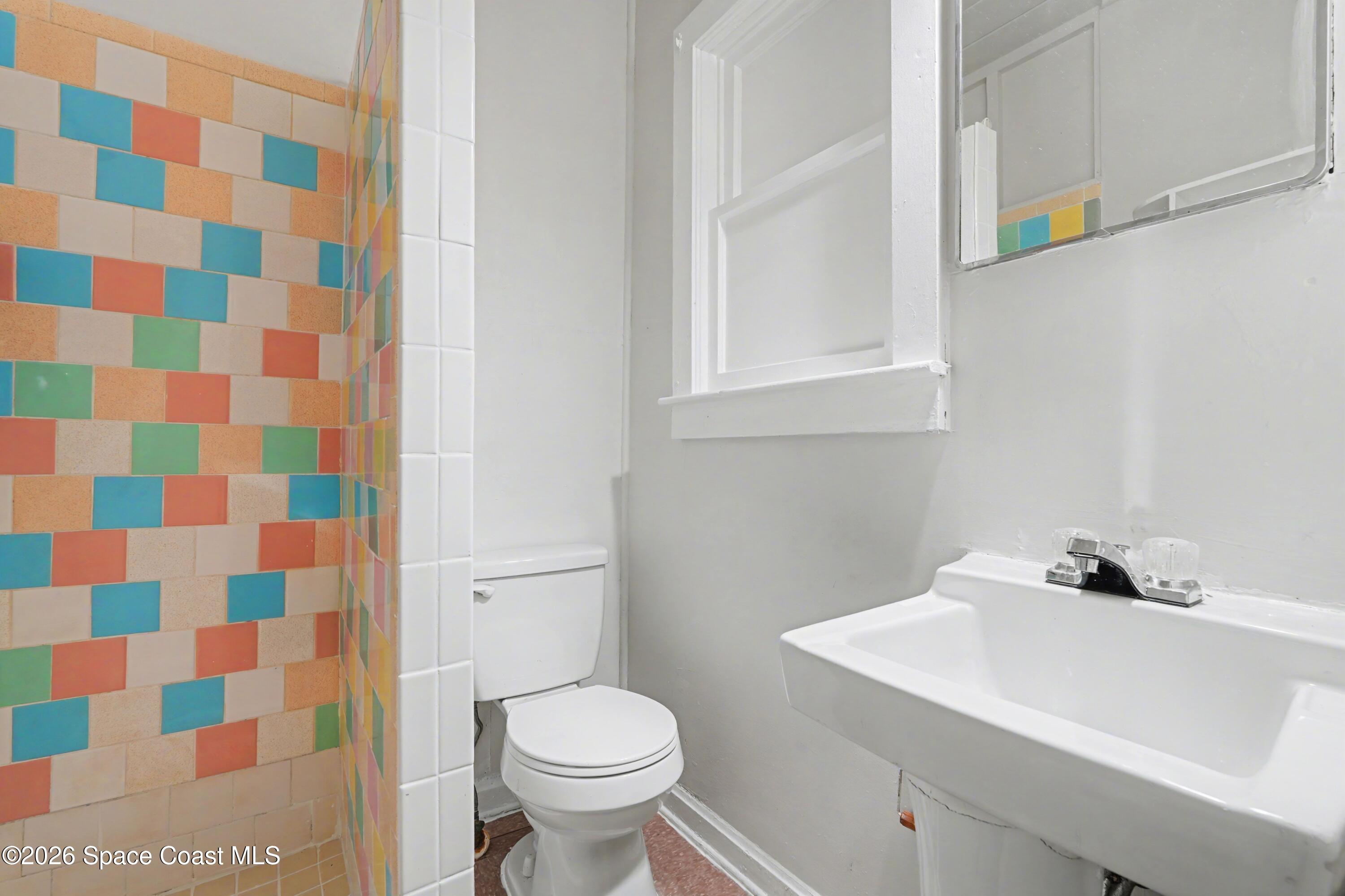 1708 Pine Street, Unit 2 Melbourne, FL 32901 - Photo 13 of 21 a bathroom with a sink toilet and shower
