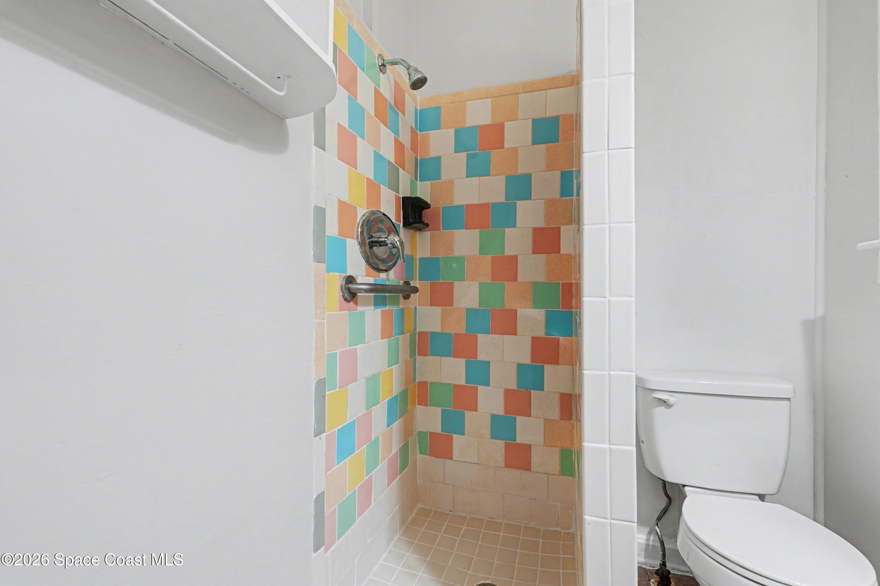 1708 Pine Street, Unit 2 Melbourne, FL 32901 - Photo 14 of 21 a bathroom with a shower curtain