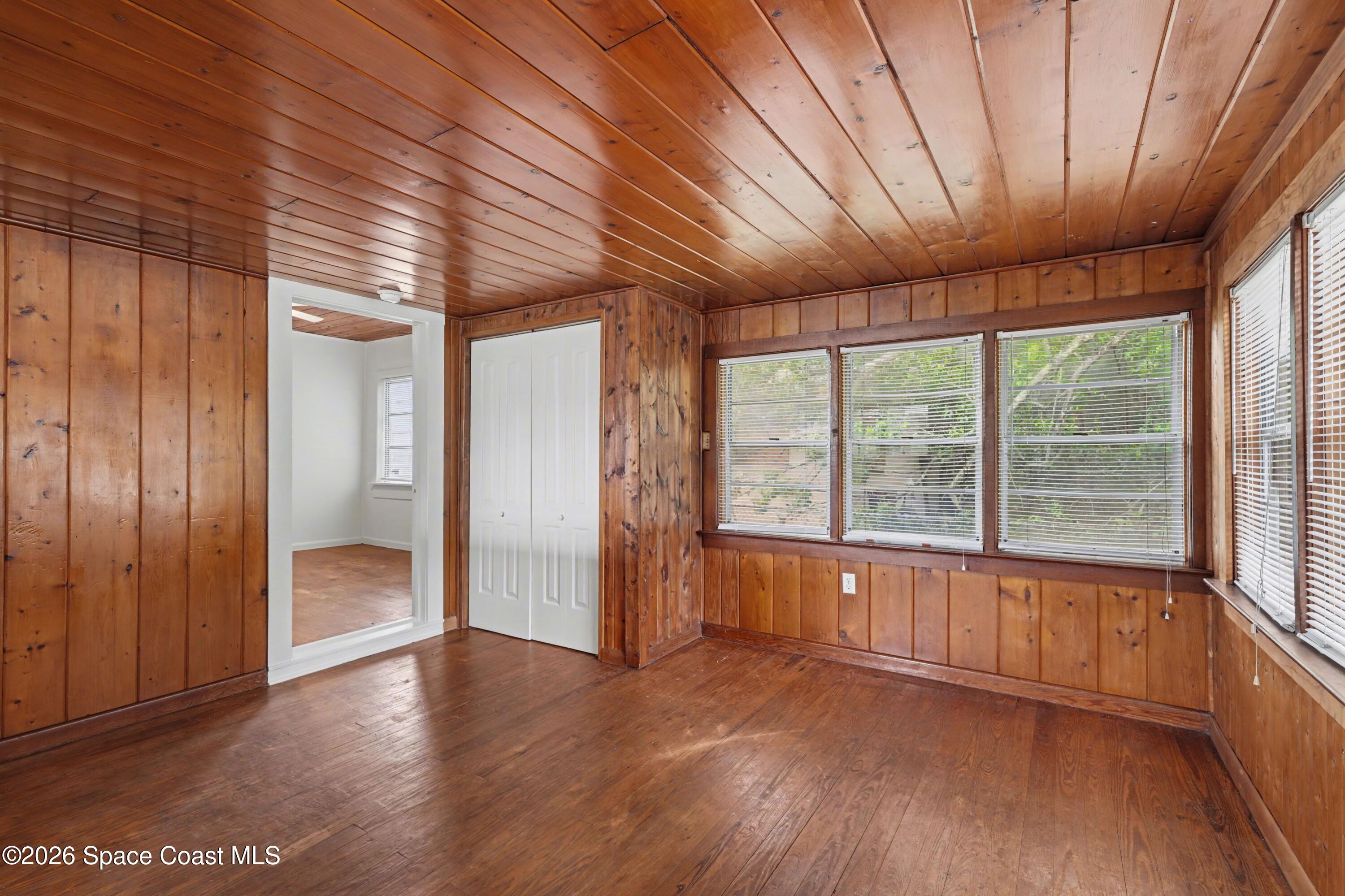 1708 Pine Street, Unit 2 Melbourne, FL 32901 - Photo 3 of 21 an empty room with wooden floor and windows