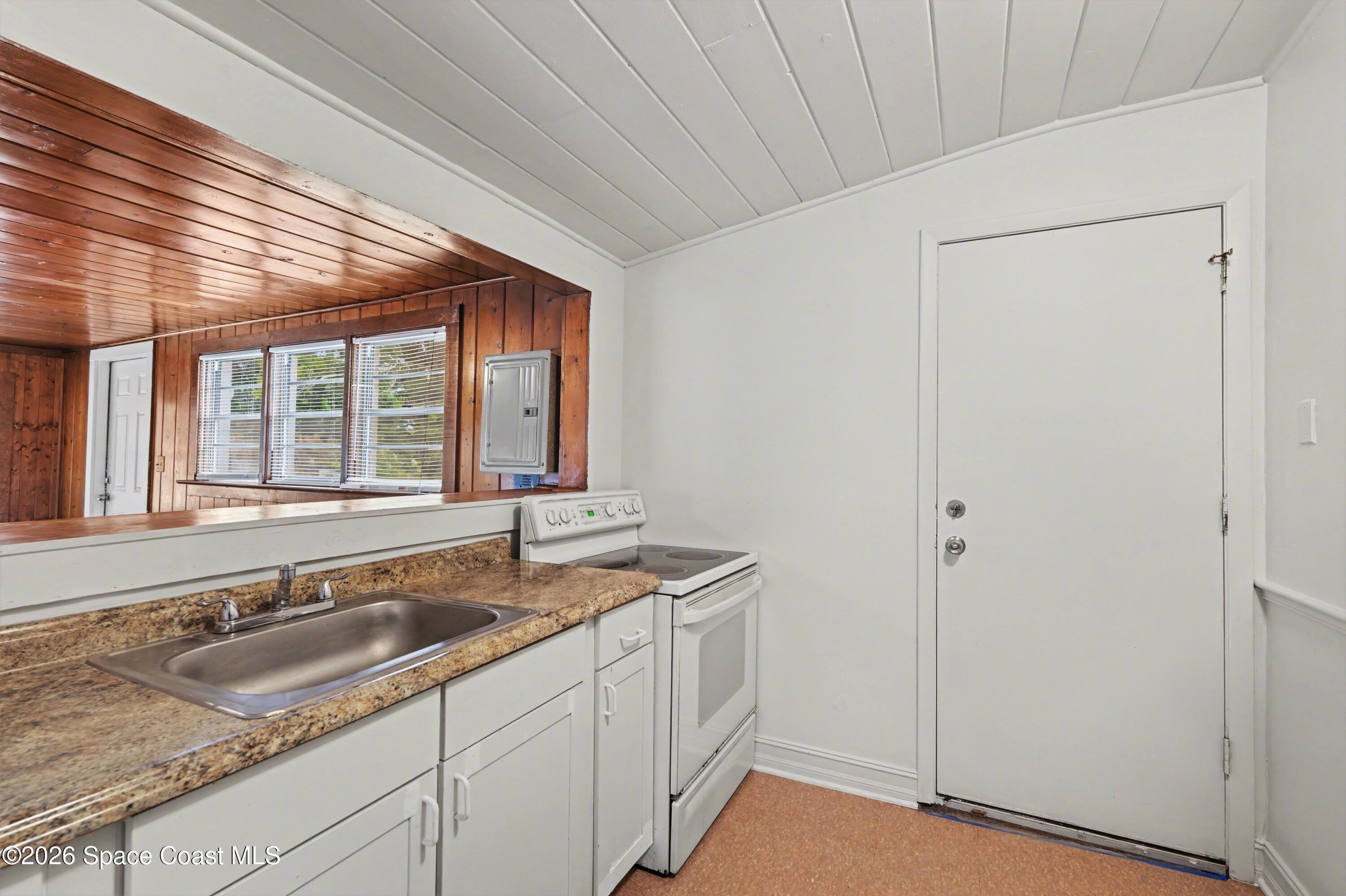 1708 Pine Street, Unit 2 Melbourne, FL 32901 - Photo 6 of 21 a kitchen with granite countertop a sink and a window