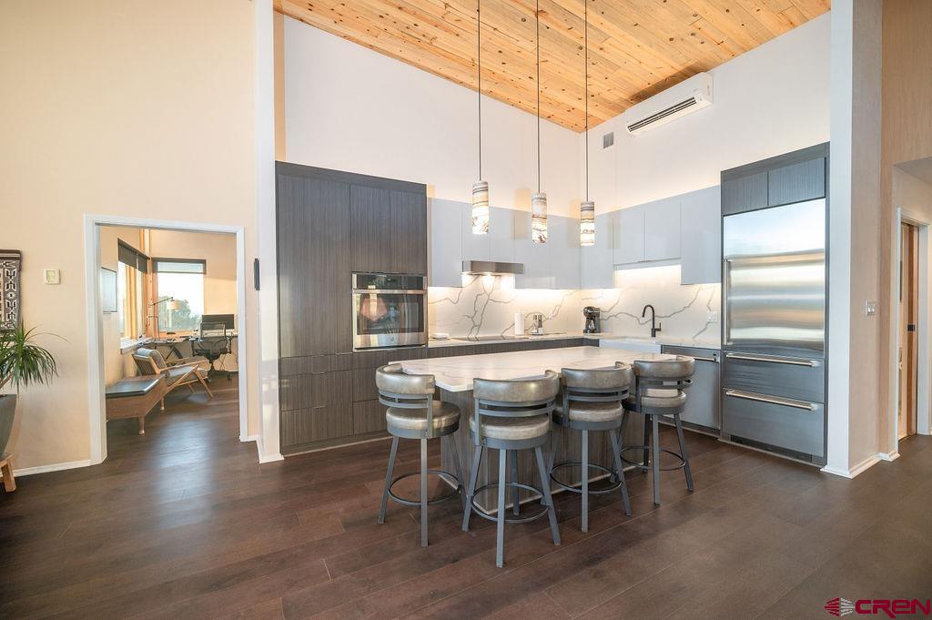 35111 Rd K.1 Mancos, CO 81328 - Photo 13 of 35 a kitchen with stainless steel appliances kitchen island granite countertop a table chairs and a refrigerator