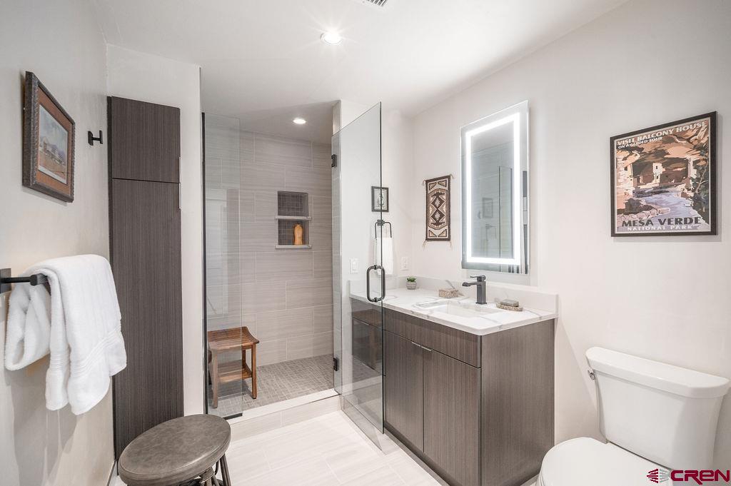 35111 Rd K.1 Mancos, CO 81328 - Photo 24 of 35 a bathroom with a toilet sink and mirror