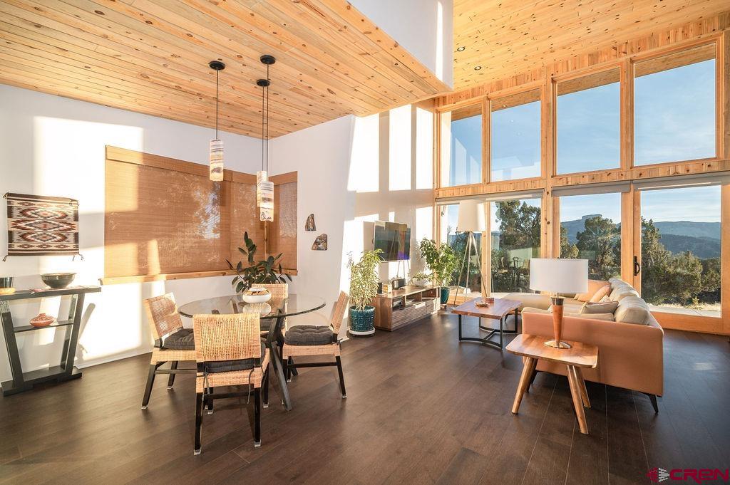 35111 Rd K.1 Mancos, CO 81328 - Photo 5 of 35 a dining room with wooden floor a chandelier a glass table and chairs