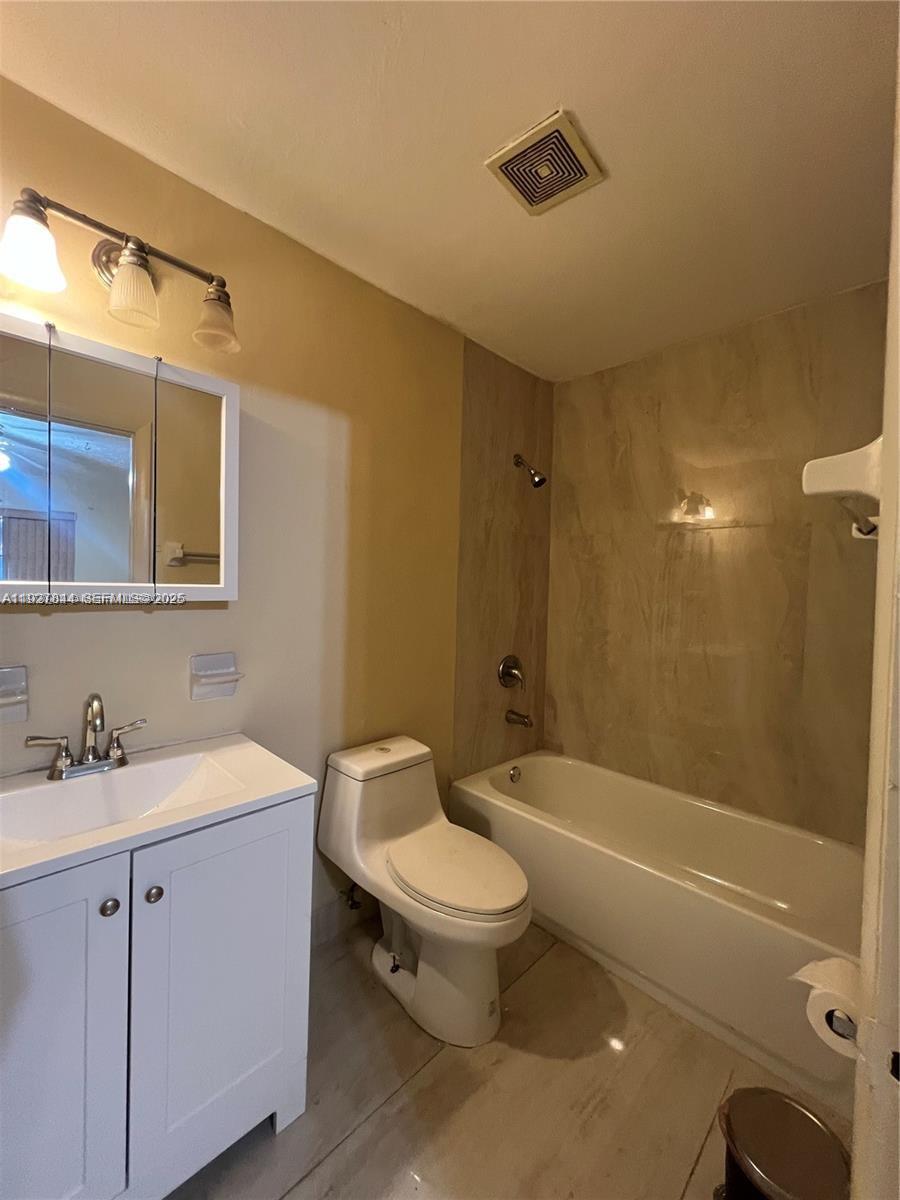 1581 Northeast 117th Street Miami, FL 33161 - Photo 12 of 29 a bathroom with a sink a toilet and shower