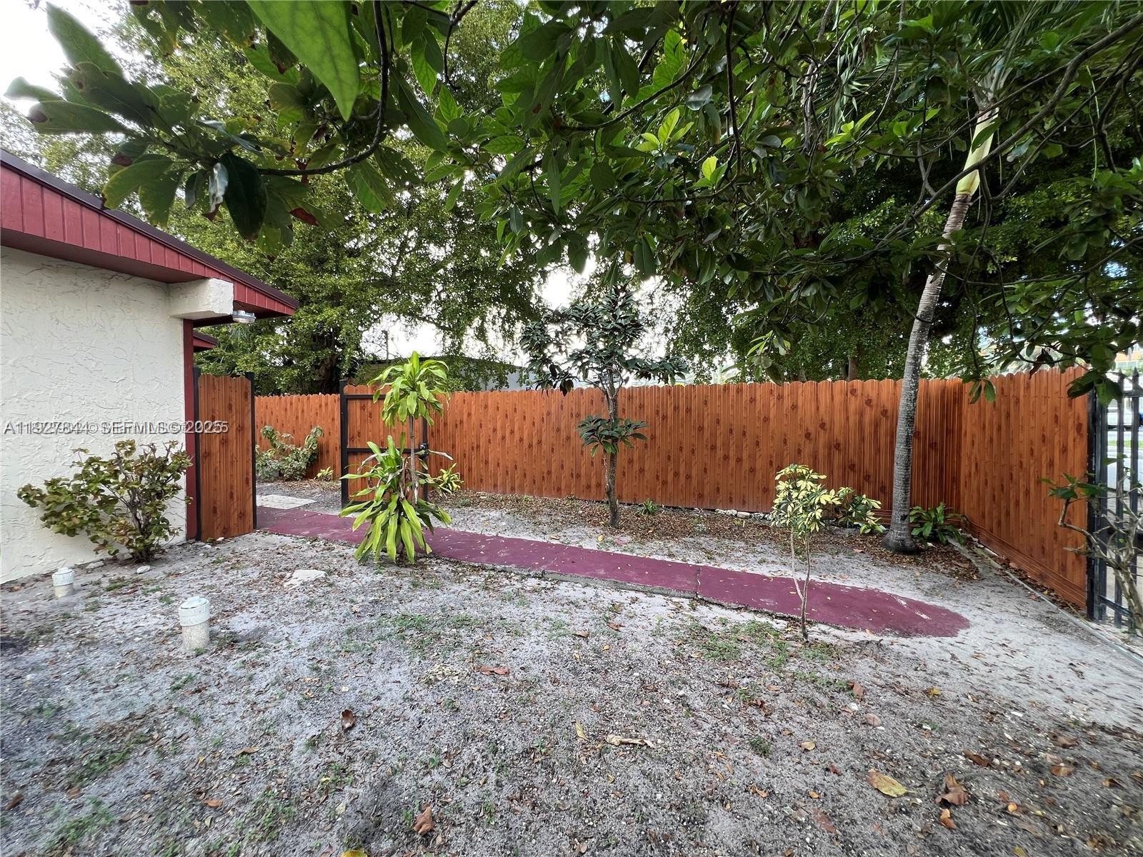 1581 Northeast 117th Street Miami, FL 33161 - Photo 18 of 29 a view of a backyard with a tree
