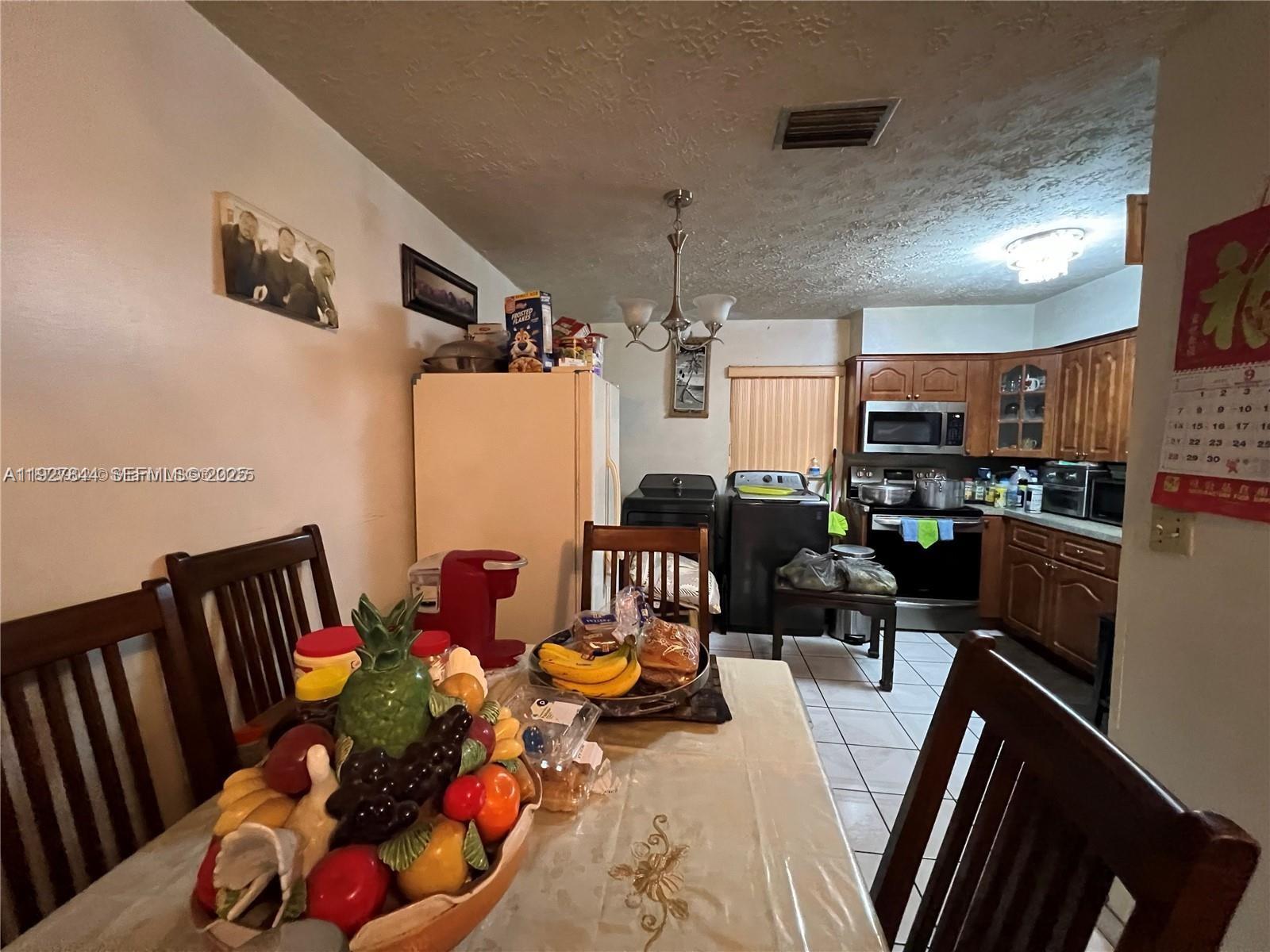 1581 Northeast 117th Street Miami, FL 33161 - Photo 20 of 29 a bedroom with furniture or couch and a potted plant