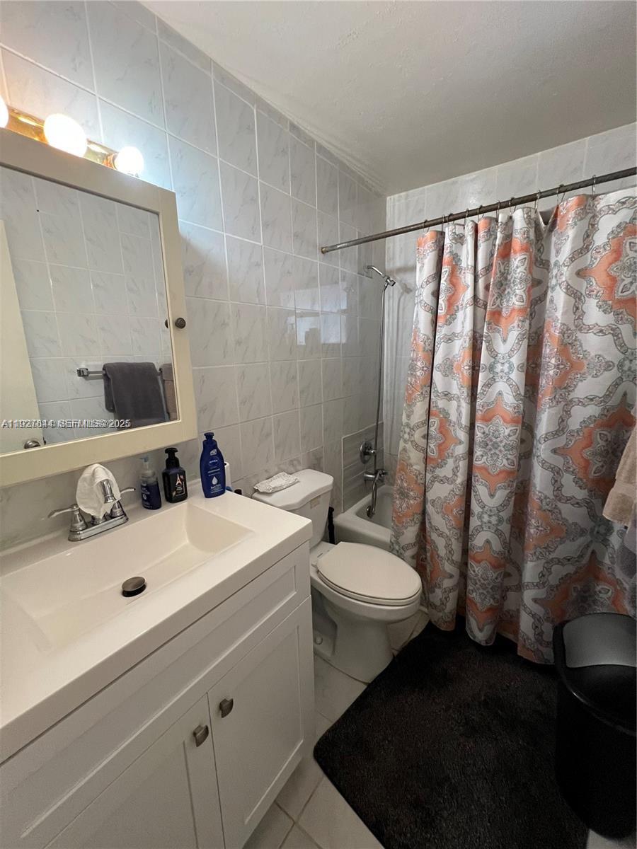 1581 Northeast 117th Street Miami, FL 33161 - Photo 21 of 29 a bathroom with a sink toilet and shower