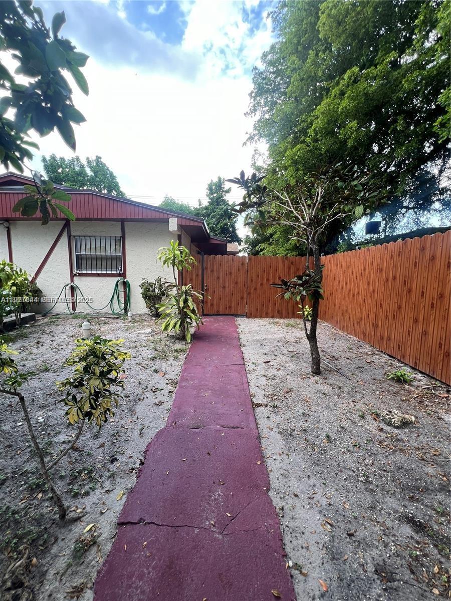 1581 Northeast 117th Street Miami, FL 33161 - Photo 4 of 29 a backyard of a house with table and chairs
