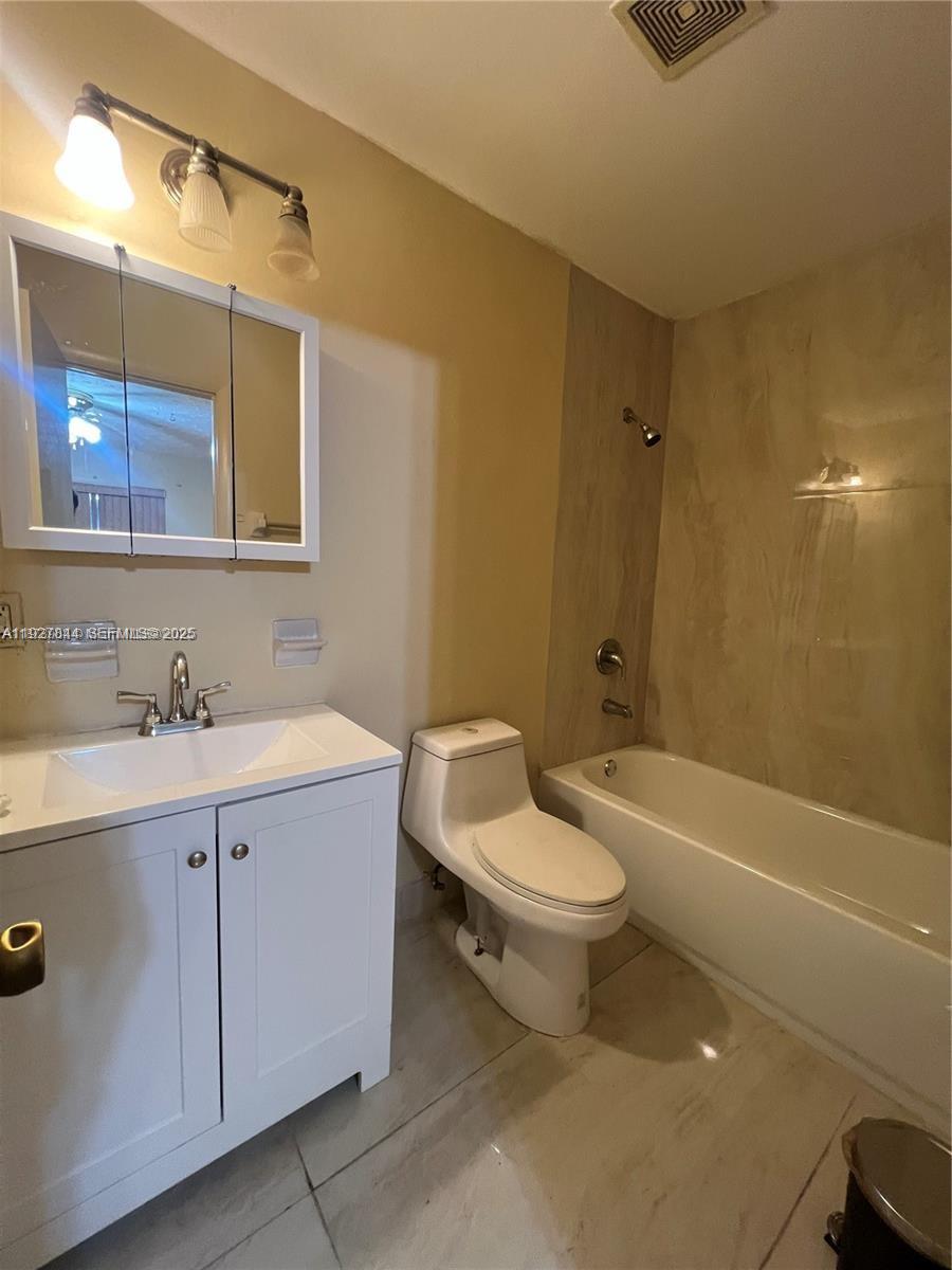 1581 Northeast 117th Street Miami, FL 33161 - Photo 7 of 29 a bathroom with a sink a toilet and bathtub