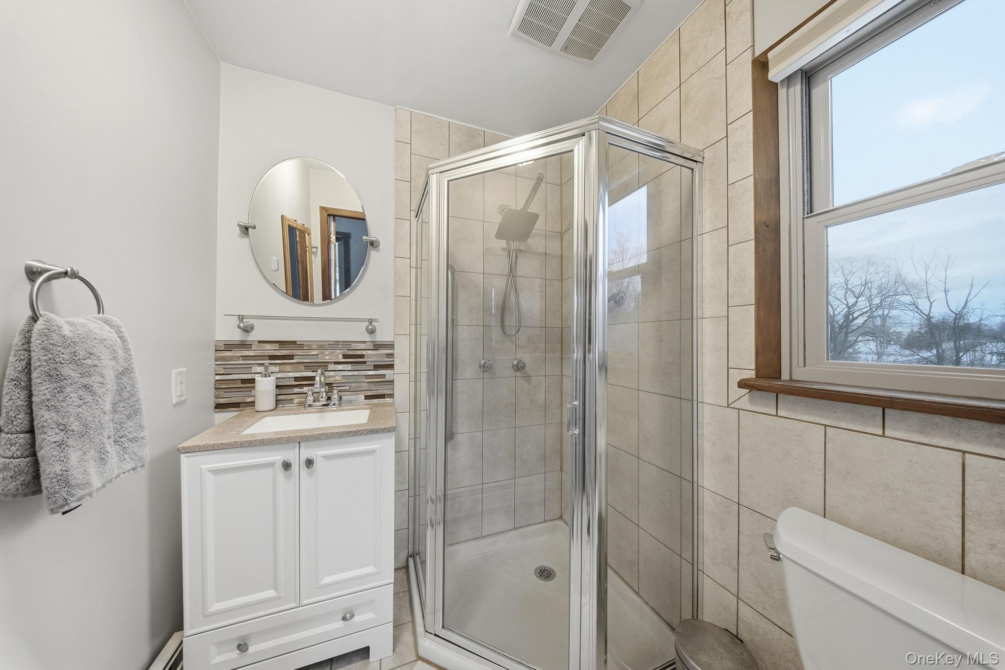 41 Low Road Wallkill, NY 12589 - Photo 24 of 37 Bathroom with vanity, a stall shower, and tasteful backsplash