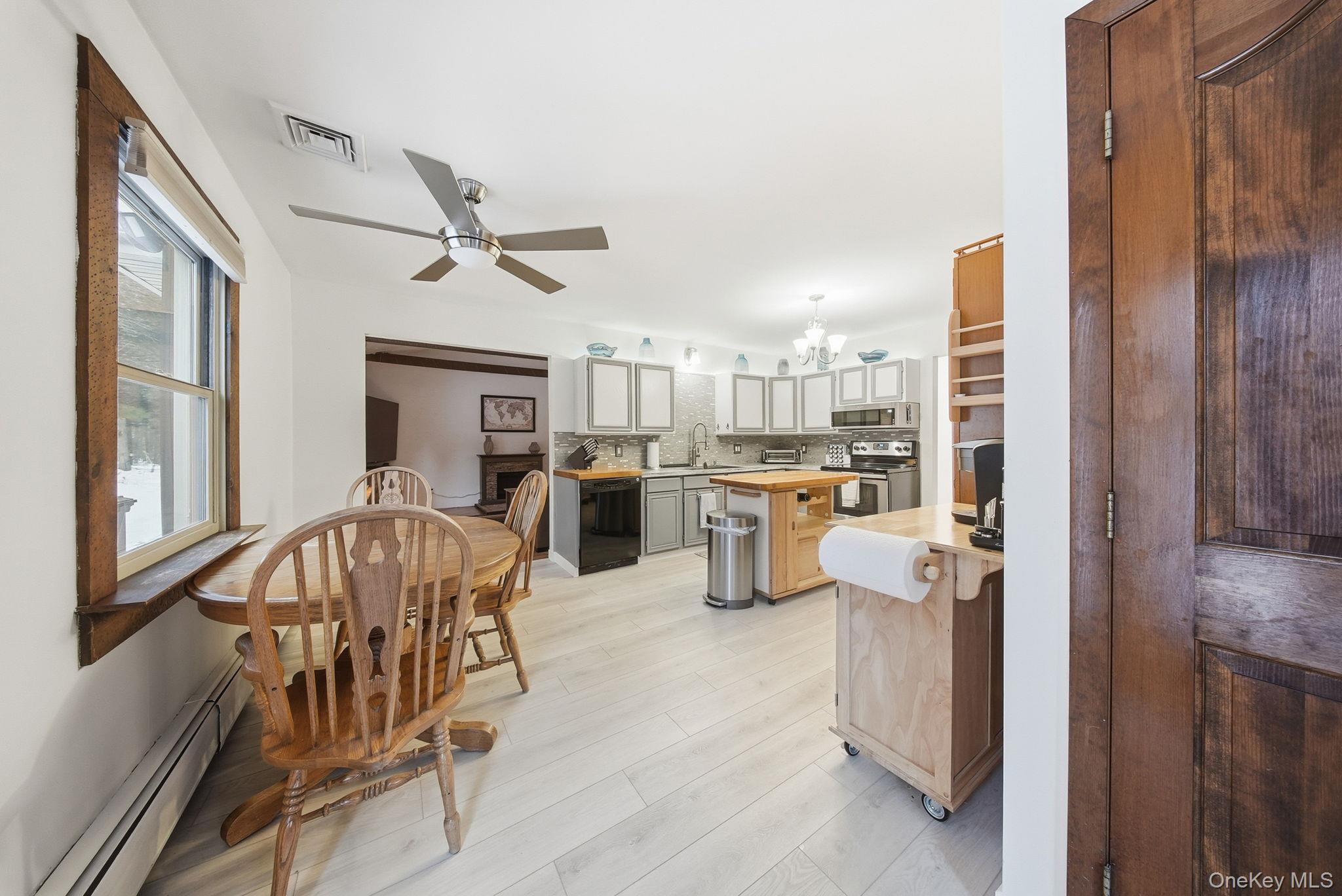 41 Low Road Wallkill, NY 12589 - Photo 10 of 37 Kitchen featuring wooden counters, a baseboard radiator, appliances with stainless steel finishes, a chandelier, and decorative backsplash