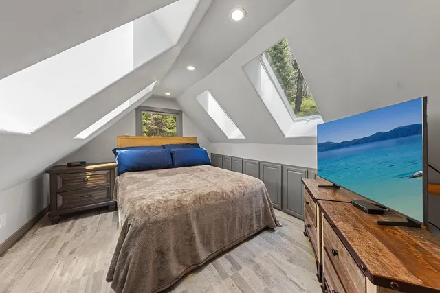 a bedroom with a bed and painting on the wall