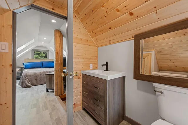 a bathroom with a toilet sink and mirror
