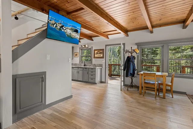 a very nice looking room with wooden floor and furniture