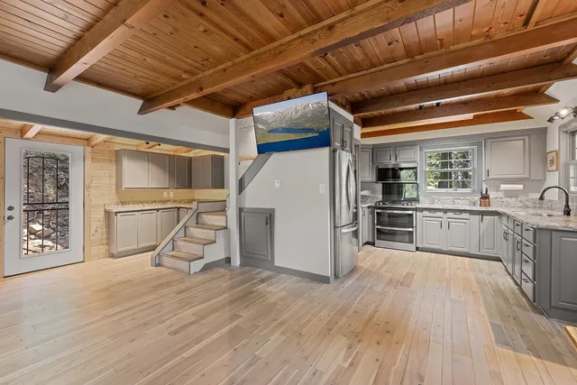 a view of a kitchen with a sink and cabinets
