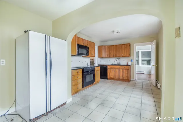 a large kitchen with cabinets and stainless steel appliances