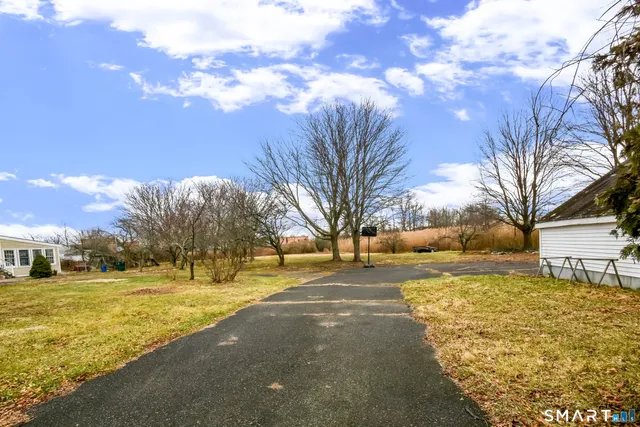 a view of yard with tree in the background
