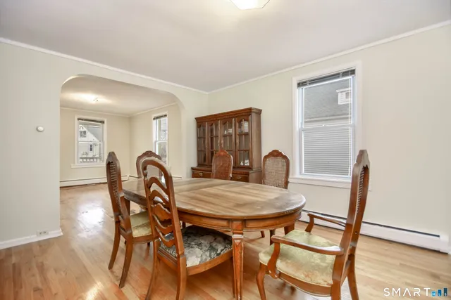 a view of a dining room with furniture and wooden floor