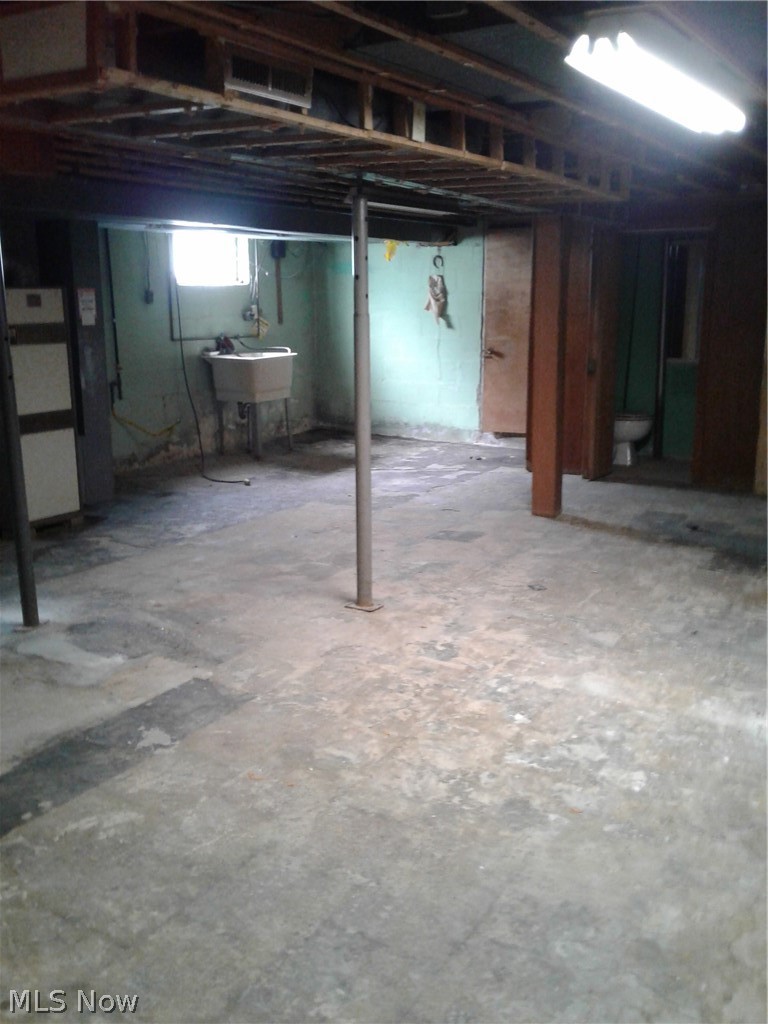 613 Jackson Street Amherst, OH 44001 - Photo 22 of 29 Basement with a utility sink and bathroom