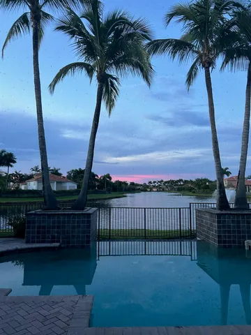 a view of a yard with a table chairs and wooden fence