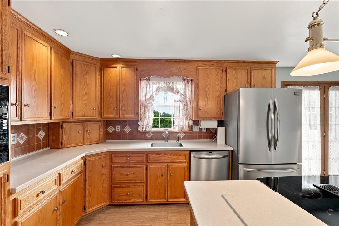 6090 Stone Post Road Bath, PA 18014 - Photo 19 of 57 A well-equipped kitchen features wooden cabinetry, sleek countertops, and stainless steel appliances.