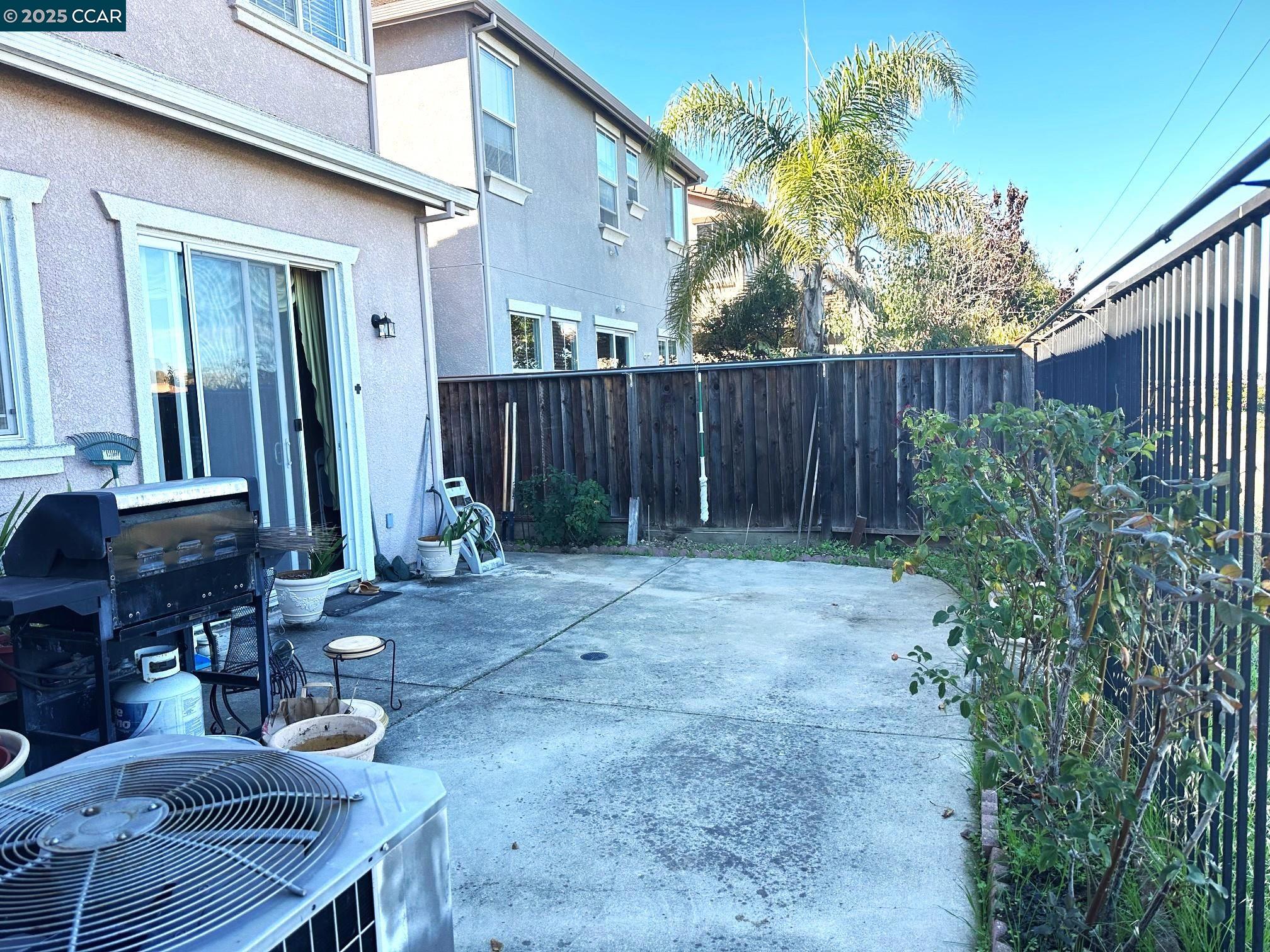 584 Silver Maple Drive Hercules, CA 94547 - Photo 19 of 19 a view of backyard with potted plants and wooden fence