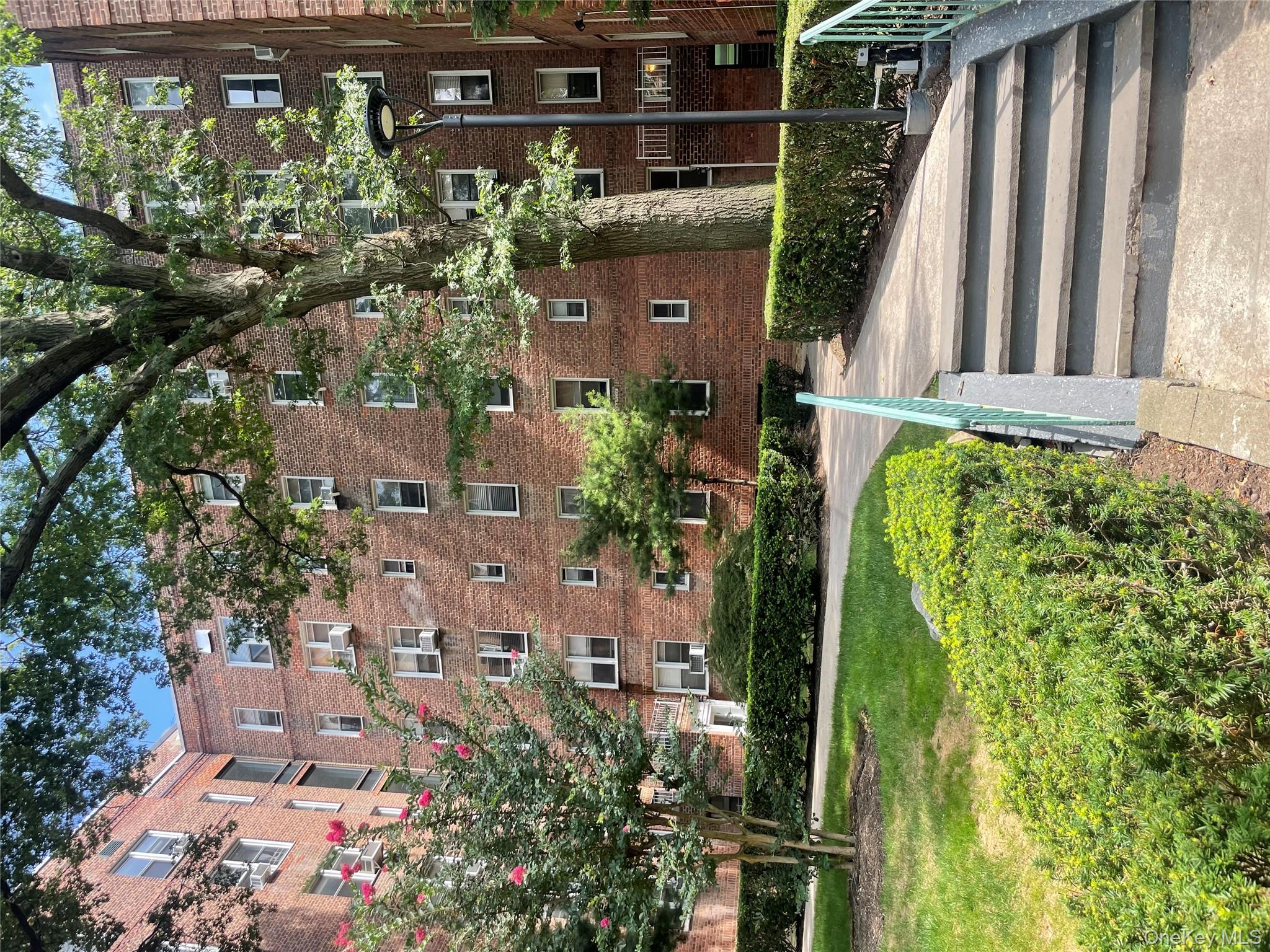 5614 Netherland Avenue, Unit 4A Bronx, NY 10471 - Photo 17 of 19 a front view of a house with a yard