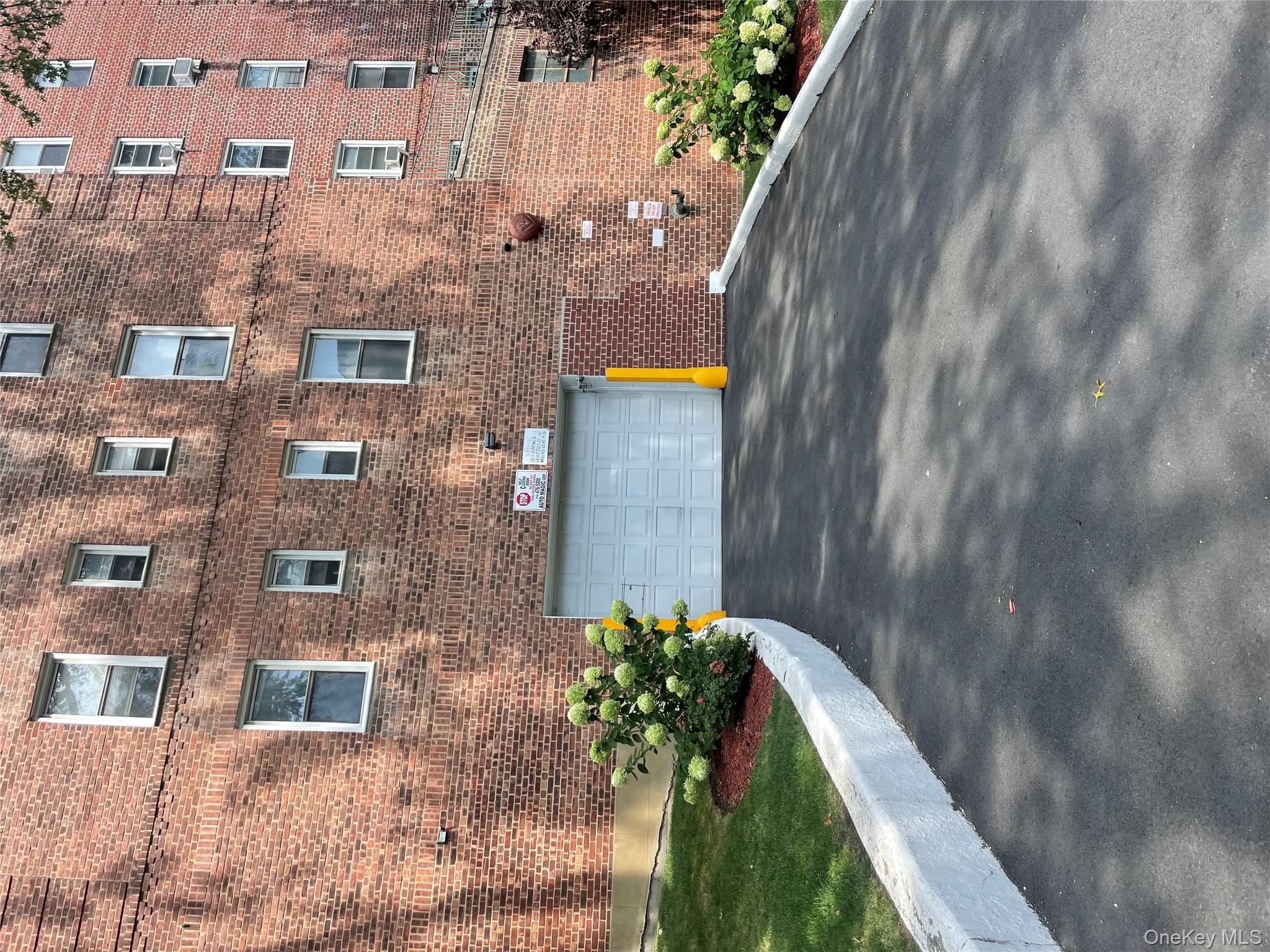 5614 Netherland Avenue, Unit 4A Bronx, NY 10471 - Photo 19 of 19 a front view of a house with a yard and garage
