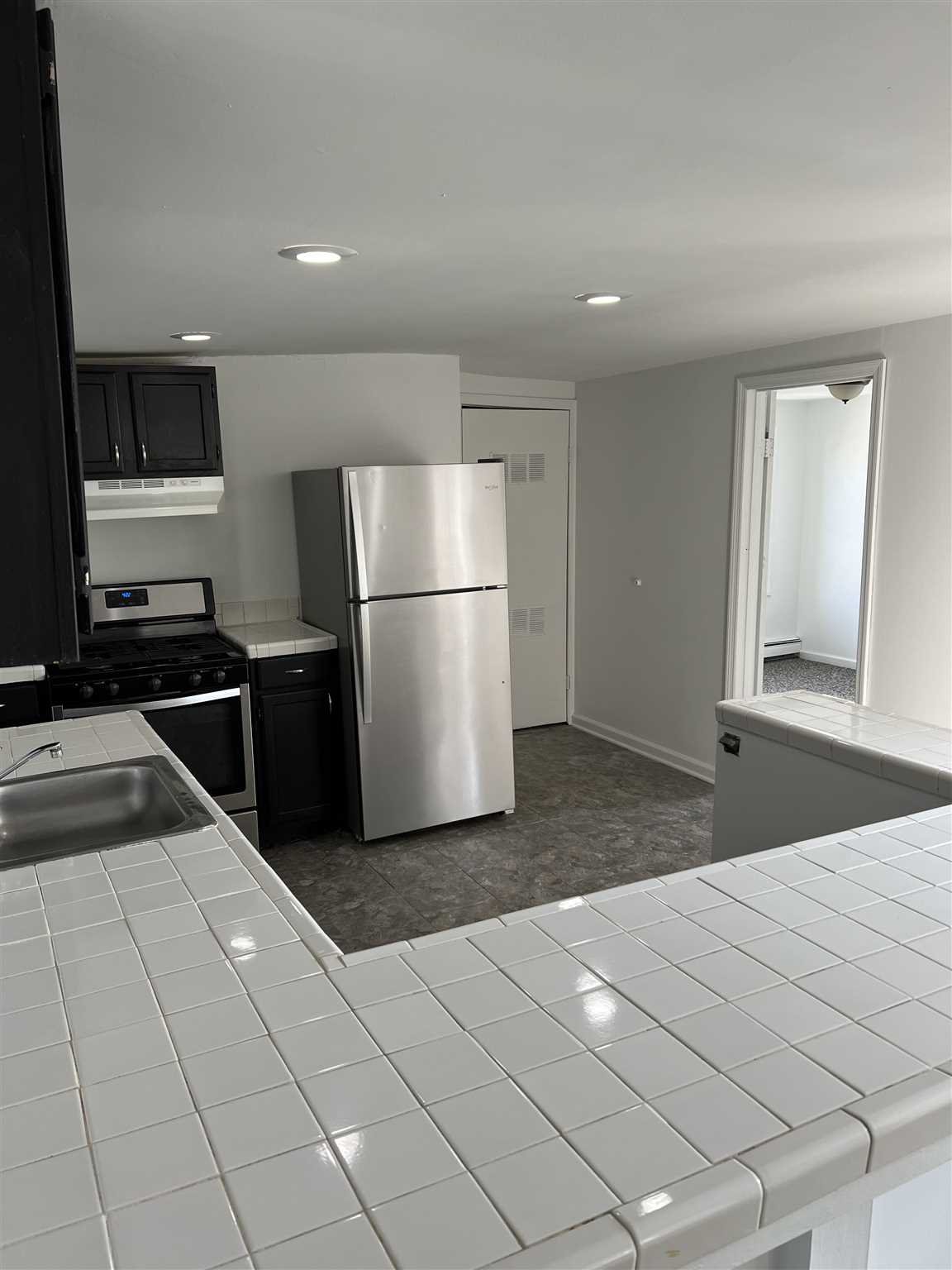 1 Dewindt Street Beacon, NY 12508 - Photo 8 of 12 a kitchen with a sink cabinets and stainless steel appliances