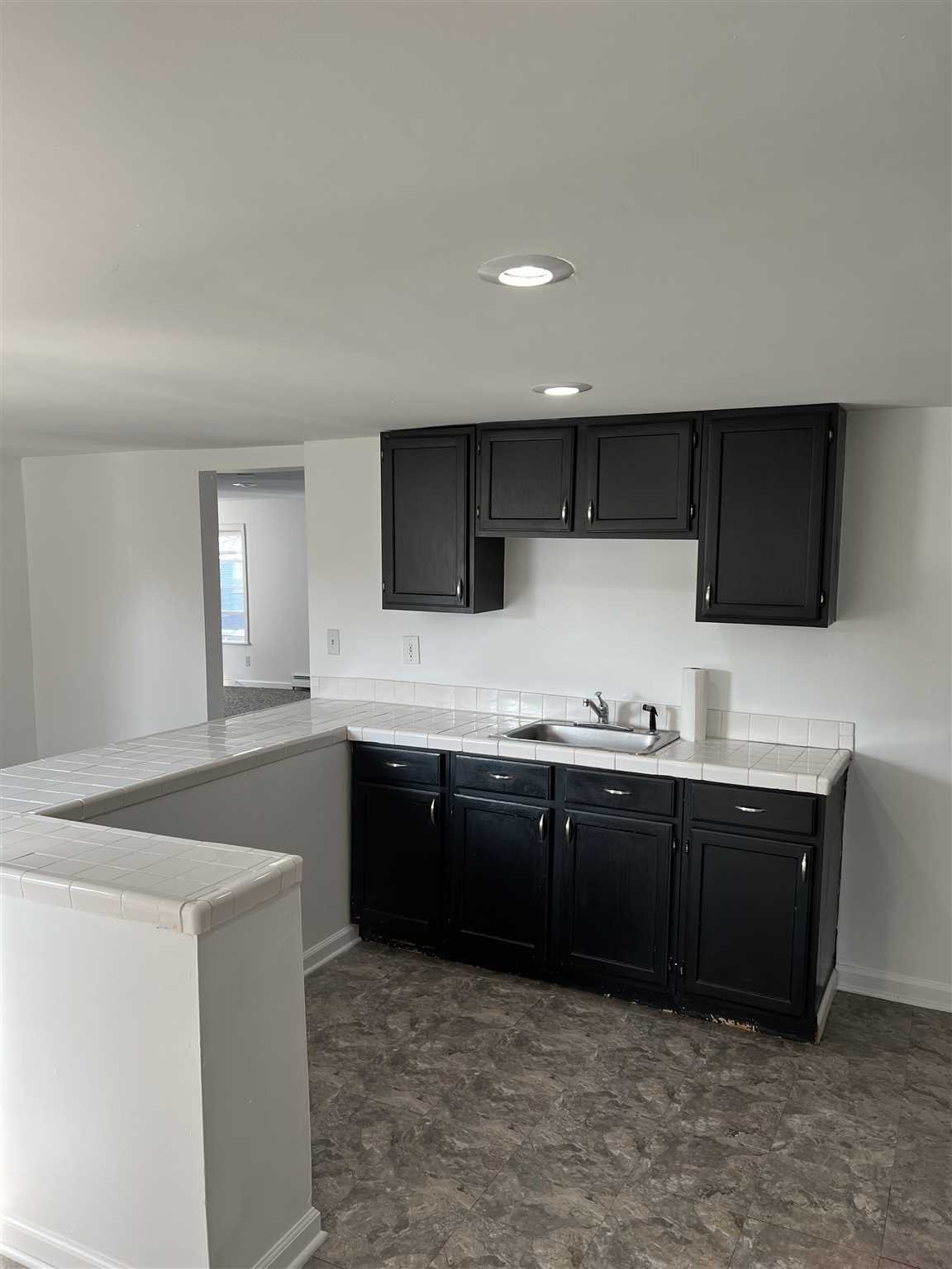 1 Dewindt Street Beacon, NY 12508 - Photo 9 of 12 a kitchen with stainless steel appliances granite countertop a sink and a stove top oven with wooden floor