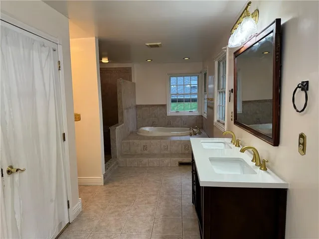 a bathroom with a sink a toilet and mirror