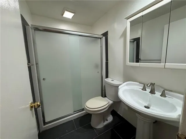 a bathroom with a sink toilet and a mirror
