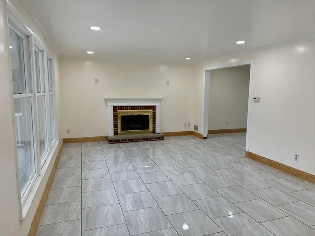 a view of empty room with a fireplace and cabinet