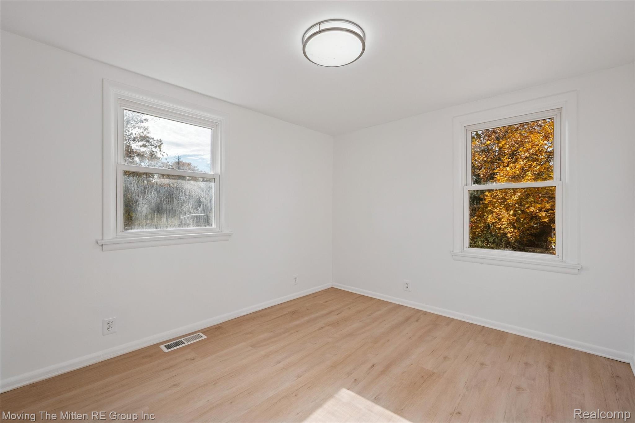 41190 Savage Road Belleville, MI 48111 - Photo 18 of 38 Empty room featuring light wood-style flooring and baseboards