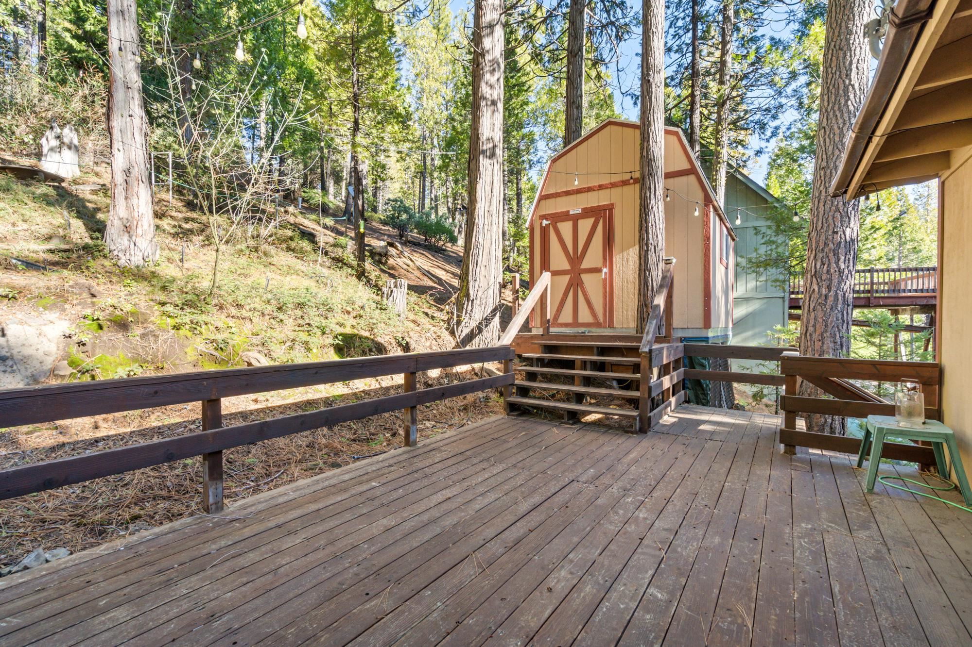 25482 Rebekah Road Long Barn, CA 95335 - Photo 18 of 42 a backyard of a house with barbeque oven and wooden floor