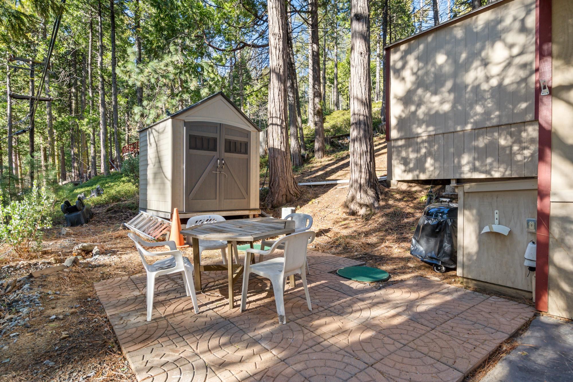 25482 Rebekah Road Long Barn, CA 95335 - Photo 27 of 42 a view of a chairs and table in backyard of the house