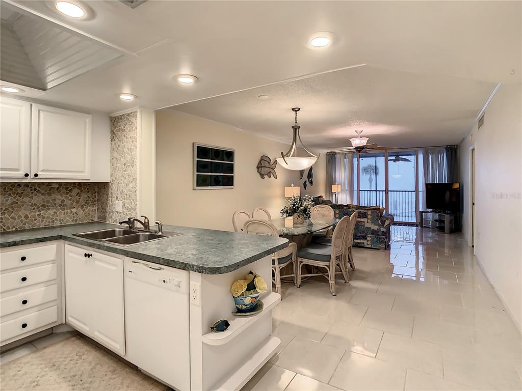 18304 Gulf Boulevard, Unit 116 Redington Shores, FL 33708 - Photo 17 of 51 a kitchen with a sink and white cabinets