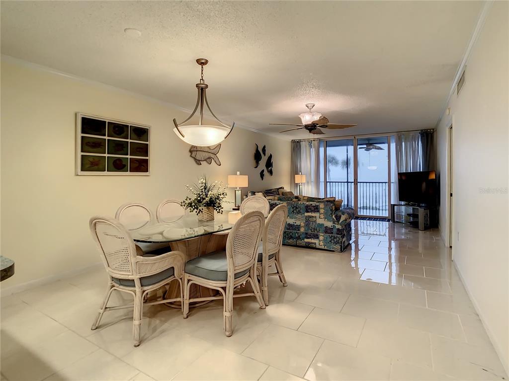 18304 Gulf Boulevard, Unit 116 Redington Shores, FL 33708 - Photo 19 of 51 a dining room with furniture and window