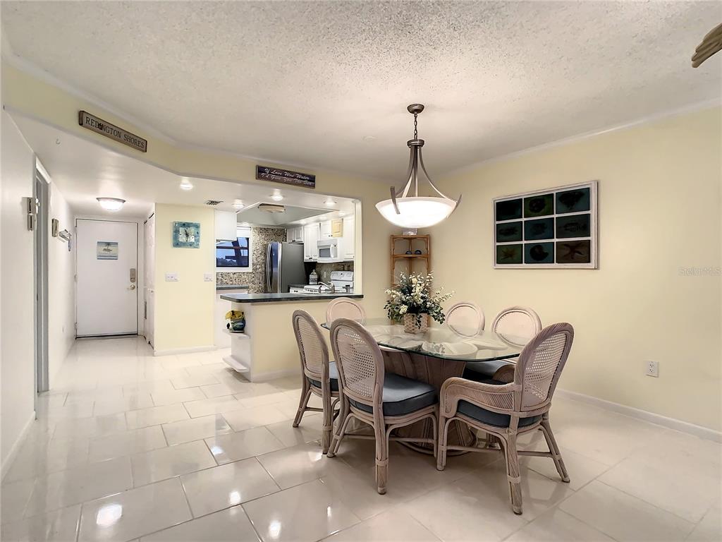 18304 Gulf Boulevard, Unit 116 Redington Shores, FL 33708 - Photo 20 of 51 a view of a dining room with furniture and chandelier