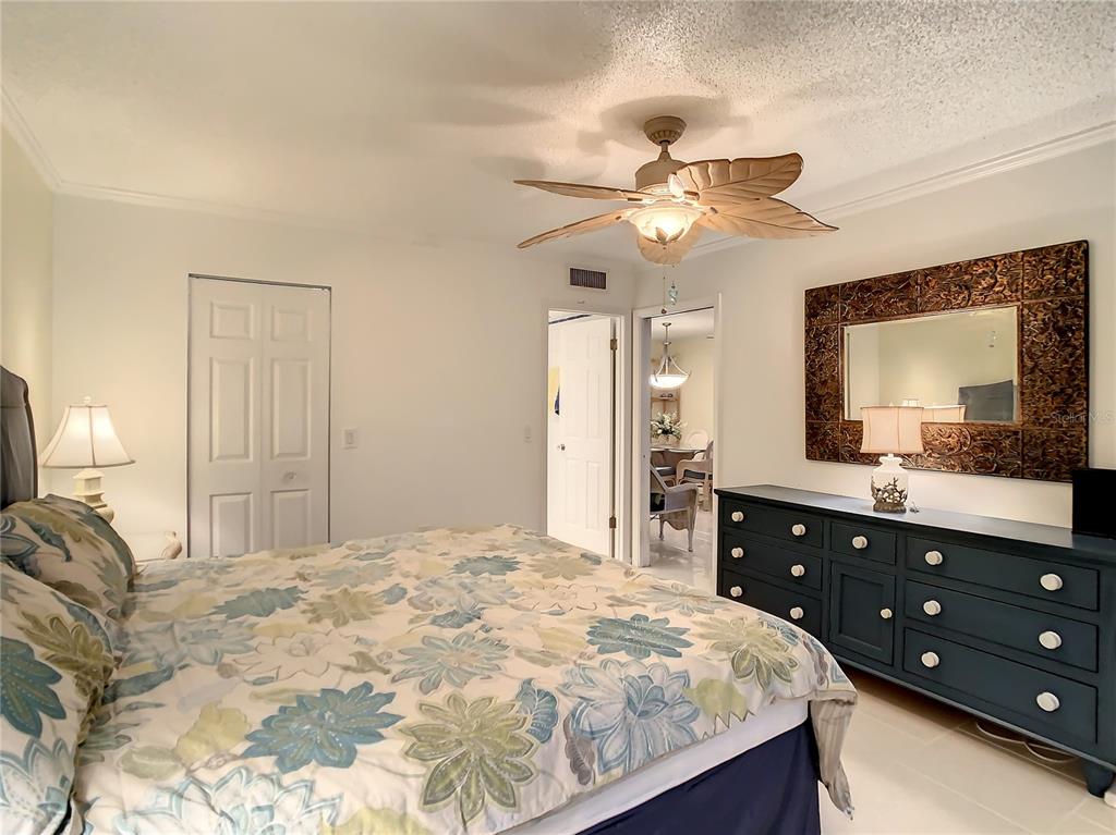 18304 Gulf Boulevard, Unit 116 Redington Shores, FL 33708 - Photo 26 of 51 a bedroom with a bed and a dresser