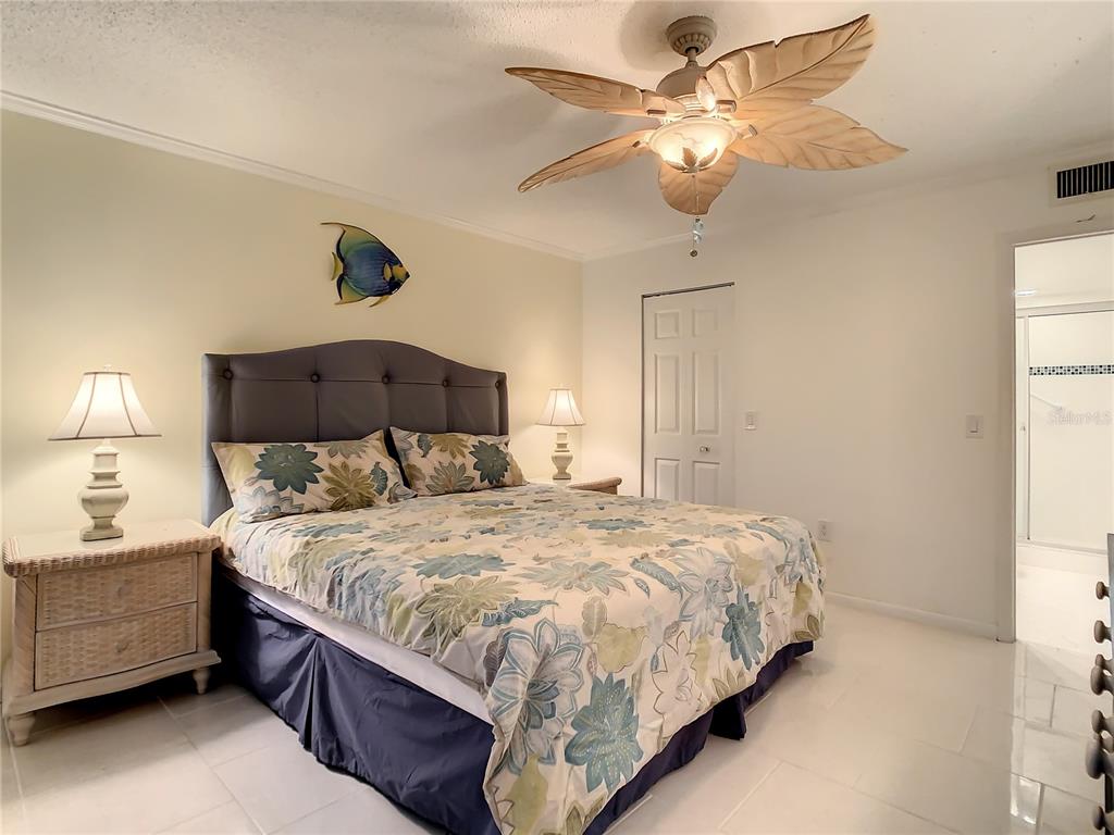 18304 Gulf Boulevard, Unit 116 Redington Shores, FL 33708 - Photo 27 of 51 a bedroom with a bed and a chandelier