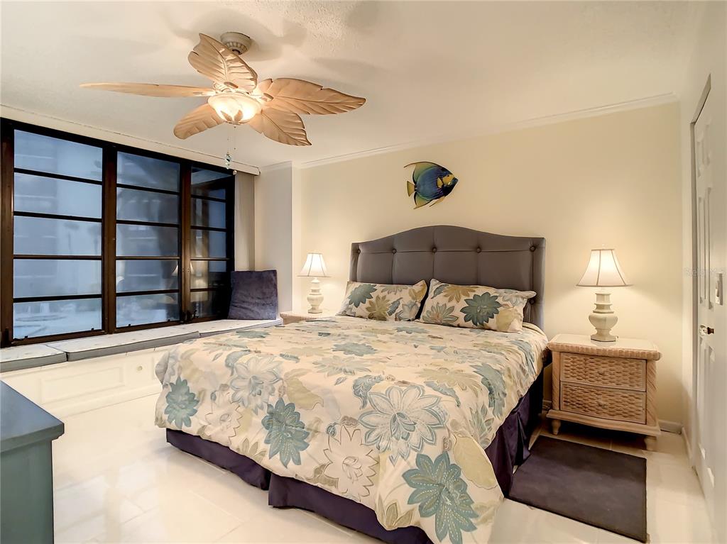 18304 Gulf Boulevard, Unit 116 Redington Shores, FL 33708 - Photo 28 of 51 a bedroom with a bed and a chandelier