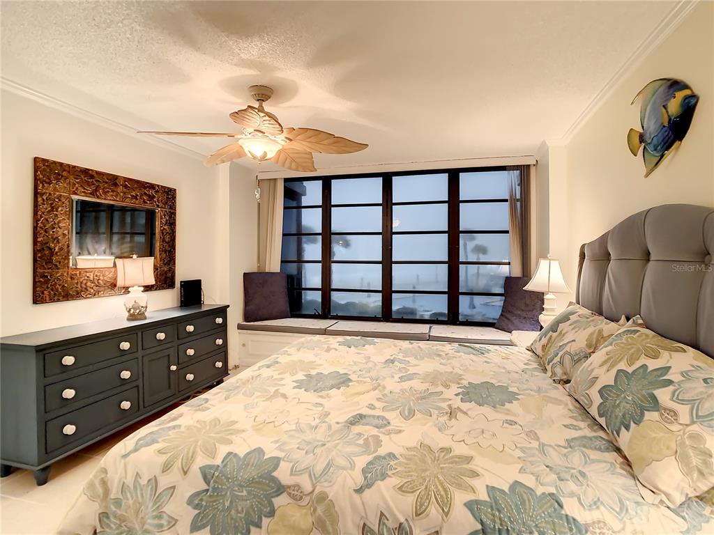 18304 Gulf Boulevard, Unit 116 Redington Shores, FL 33708 - Photo 30 of 51 a bedroom with a bed and a dresser