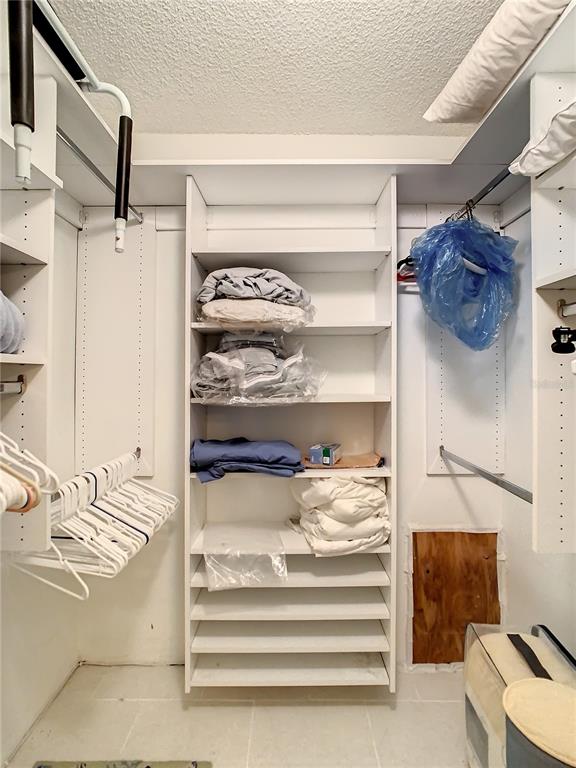 18304 Gulf Boulevard, Unit 116 Redington Shores, FL 33708 - Photo 32 of 51 a view of walk in closet with empty racks